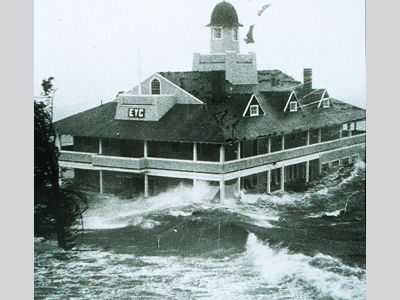 Waves rising to the second story of a building