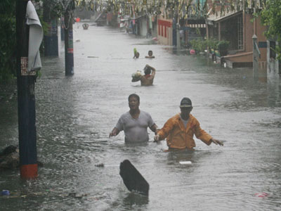 People walking in water waste deep.