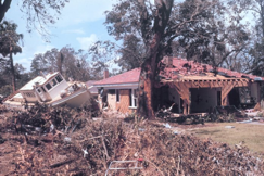 A boat next to a destroyed house